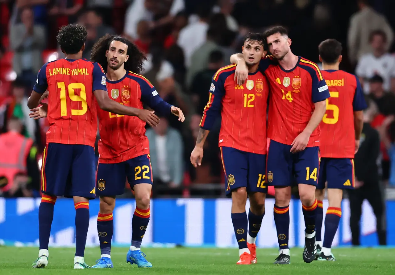 Lamine Yamal, Marc Cucurella, Marc Pubill, and Aymeric Laporte of Spain celebrate after winning the UEFA Nations League