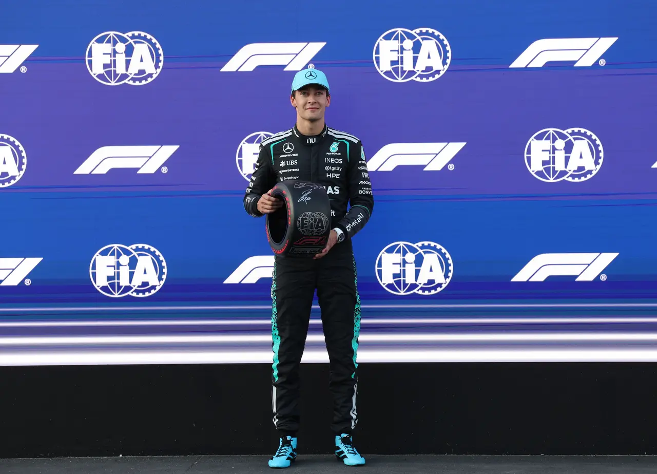 Mercedes driver George Russell of Britain receives the pole position award after the Qualifying for the Formula One 