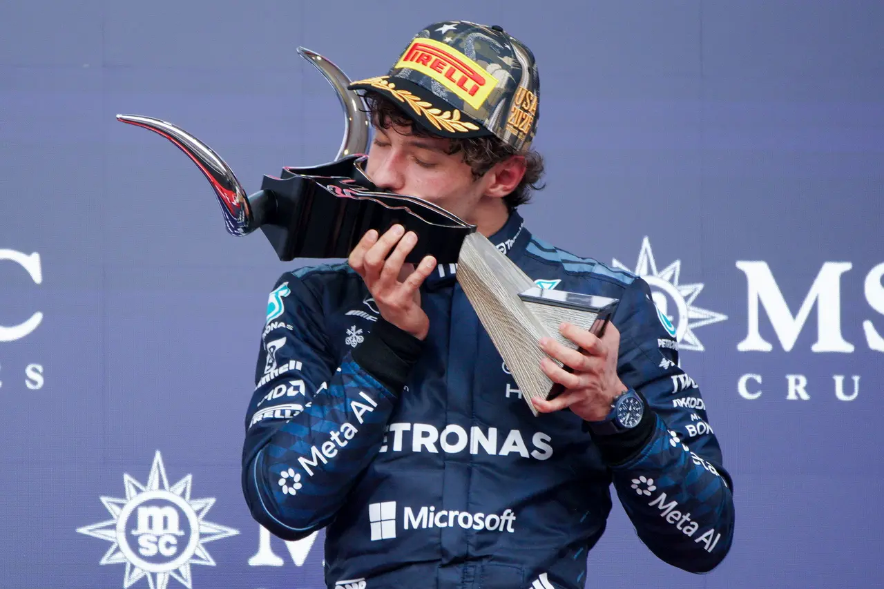 Mercedes driver Andrea Kimi Antonelli of Italy kisses the first place trophy on the podium after winning
